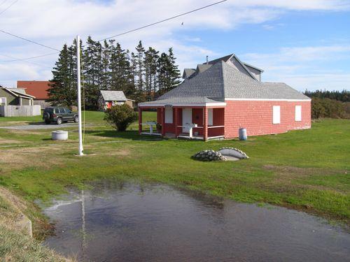 A northwest perspective view of the Little School Museum in its setting in the Town of Lockeport, NS.; NS Dept of Tourism, Culture & Heritage, 2009