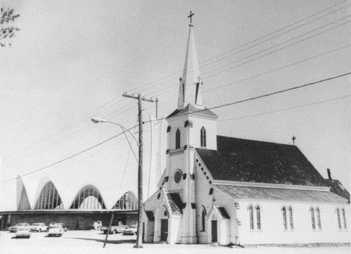 Image of the new church beside the old church prior to its demolition.  The former church was built in 1864.; Private collection