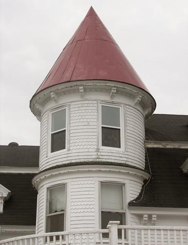 The house's tower with decorative shingles and ornate brackets under the eaves; Bernard LeBlanc