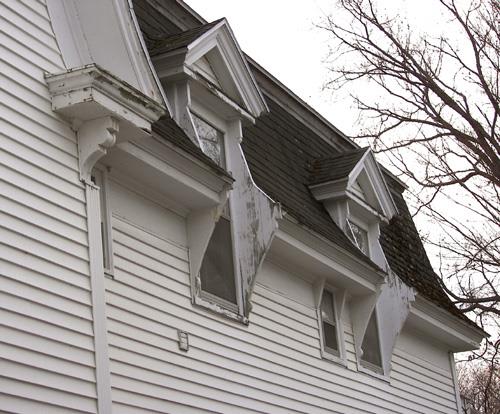 Pedimented dormers with vertical woodwork serving as extended brackets; Bernard LeBlanc