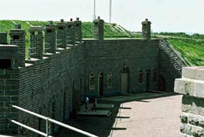 General view of the casemates bordering the Parade ground, 1982.; S. MacKenzie, Parks Canada Agency / Agence Parcs Canada, 1982.