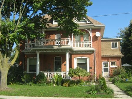 Of note is the second storey balcony with decorative wood details; Martha Fallis, 2008.
