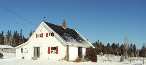 Image of the Bancroft House in winter 2010 showing the fields on the right of the house; Grand Manan Historical Society