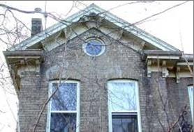 Featured is the gable roof with bracket details and circular window in the facade.; City of Brantford, 2008.