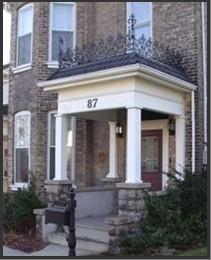 Featured is the elaborate veranda with low cut stone walls.; City of Brantford, 2003