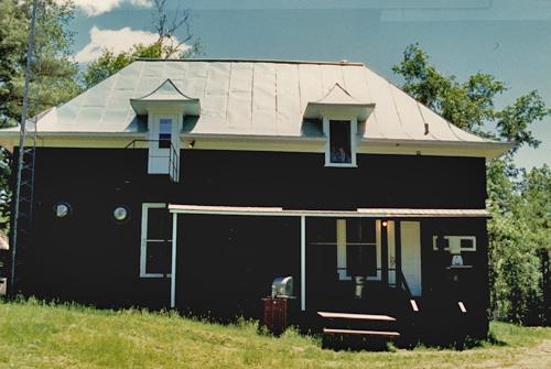 View of Wabenaki Lodge, showing the verandah attached to the northeastern façade, 1990.; Canadian Parks Services / Service canadien des parcs, 1990.