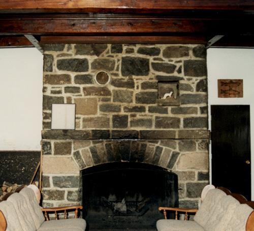 Interior view of Wabenaki Lodge, showing the quarry stone fireplace, 1990.; Canadian Parks Services / Service canadien des parcs, 1990.