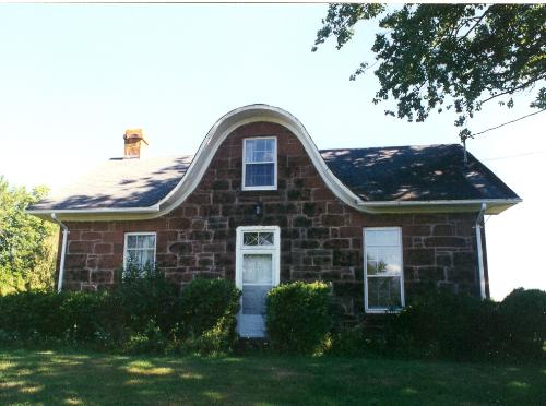 Showing sandstone construction and "nun's hood" dormer; Province of PEI
