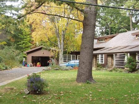 Of note are the shallow shed dormers and the extended roof.; Paul Dubniak, 2009.