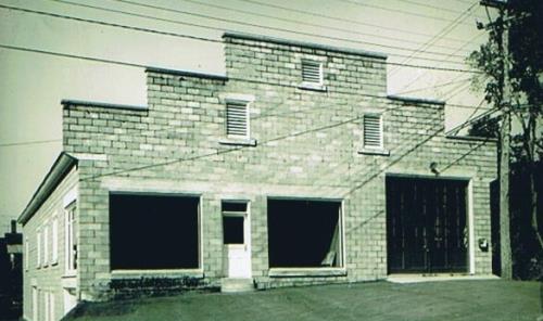 Picture is taken in the 1960's of the Town Hall shortly after it was purchased by the town from a Massey Harris dealership operated by Ercel Orser; Doris E. Kennedy