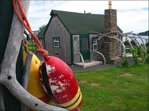 This image shows one of the cottages at Whale Cove in its peaceful setting.; Linda L'Aventure