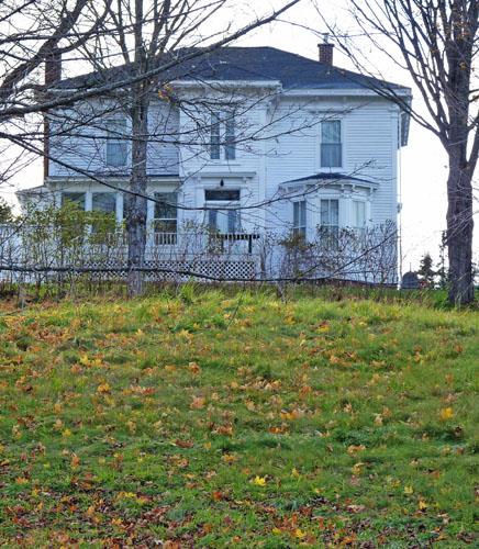 This image shows the imposing house accentuated by the well-mantained collection of outbuildings which attend it.; Village of Hillsborough