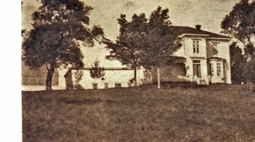 Image of the estate looking west from Main Street circa 1900. The manor house looks out over the village of Surrey.; Village of Hillsborough, William Henry Steeves House Museum archives
