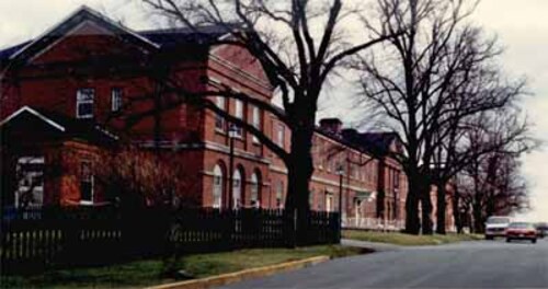 Side view of Wellington House, showing the north façade and the two-storey massing of the building.; Parks Canada | Parcs Canada, Canadian Forces, NS-85-6-5681