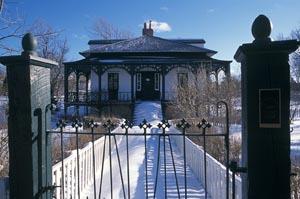 Front view of Hawthorne Cottage, showing the square, one-and-a-half storey massing and the varying roof types, 2004.; Parks Canada Agency / Agence Parcs Canada, 2004.