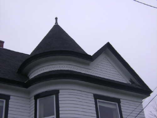 This photograph illustrates the unique tower with a conical roof and pediment, 2009; Town of St. Andrews