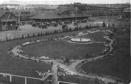 Exterior southeast view of the Canadian Pacific Railroad Station, gardens, and rail yards, Red Deer (1912); Red Deer and District Archives, p-125-p-1-2