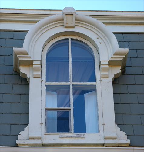 This image shows the upper storey window details of the Thomas Linton Residence; City of Saint John