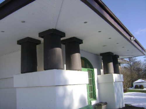 This photograph shows the pillars and overhanging eaves of the south wing, 2009; Town of St. Andrews