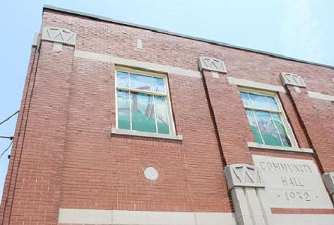 Three windows on facade feature images of oil heritage (jerker-line, oil wagon, three pole derrick); Photographs taken by Dana Johnson, May 31st, 2010