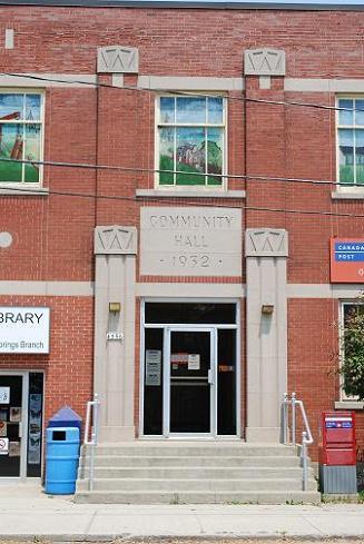Original entrance, flanked by two fluted pilasters with a sign that reads, “Community Hall 1932".; Photographs taken by Dana Johnson, May 31st, 2010.