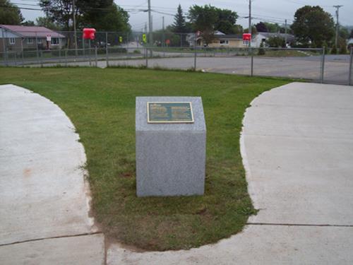 View down Donaldson Street which was built over the old airport runway and the Commemorative Monument that was installed in 2010.; Department of Wellness, Culture and Sport - Heritage Branch