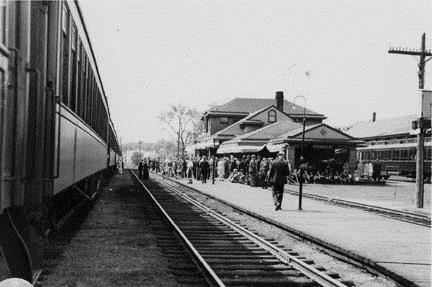 Image of the York Street Train Station showing a waiting crowd gathered in front of station; Private Collection