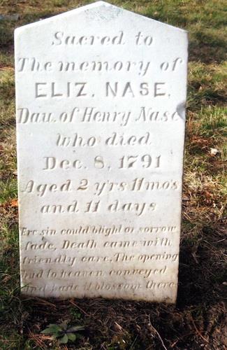 White marble marker for what is believed to be the first burial in the cemetery; Grand Bay-Westfield