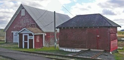Prefab section shed, the type built in Hillsborough and sold to railways throughout North America.  In the background is a finished product storage barn built as part of the 1873 plaster mill.; Village of Hillaborough