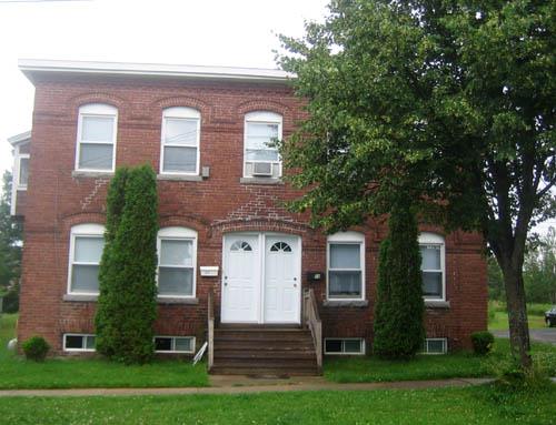 Front view of the brick dwelling, showing the symmetrical façade and the double entrance.; City of Fredericton