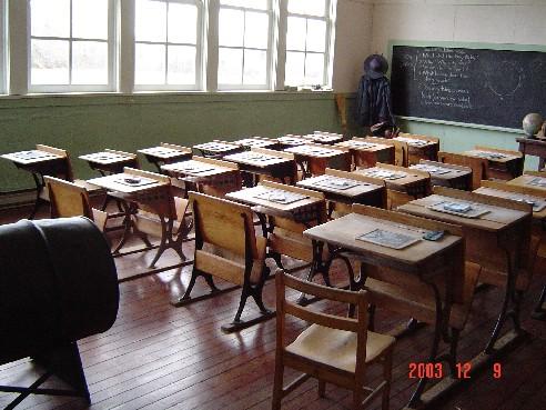 Interior view of Lochiel School showing school desks, blackboard and large windows.; Township of Langley, Julie MacDonald, 2003.