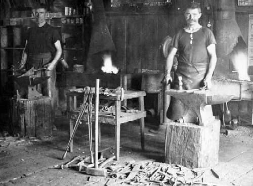 G. Robbie Moir and William Tarves at work in Moir's blacksmith shop circa 1909.; Township of Langley, Serial No.459