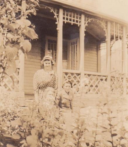 Historic photo showing the original deck on the left facade of John William Caines House, Norris Point, NL.; © HFNL 2010