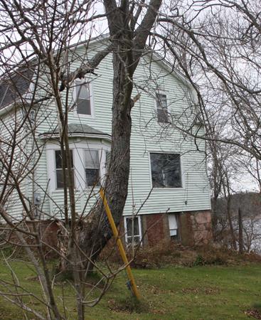 Side view of the George W. Crawford House showing the exposed portion of the foundation.; Grand Bay-Westfield