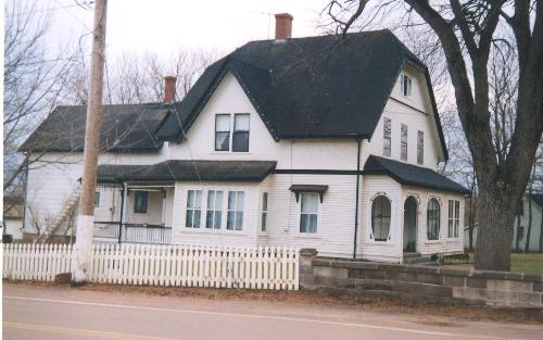 Showing hipped gable roof, verandahs, and shingle styles; West Prince Acadian History Committee