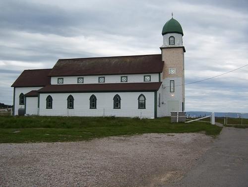 Exterior photo, north facade, Holy Trinity Church, Codroy, Newfoundland, 2006, showing restoration work in progress.; HFNL 2006