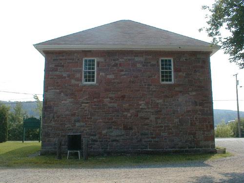 This image displays the cut stone, broken course walls made of red sandstone.; PNB 2004