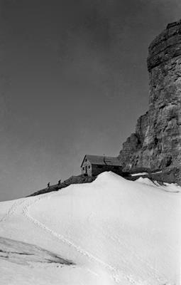 General view of Abbot Pass Refuge Cabin, showing its simple massing as one-and-a-half-storey rectangle under a pitched roof, 1930.; Parks Canada Agency / Agence Parcs Canada, 1930.