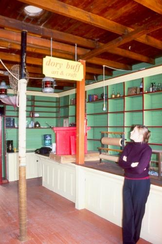 Interior photo of Kean's General Store, Brookfield, Newfoundland, showing Janet Davis, proprietor of the Norton's Cove Studio, which operates out of the building.; HFNL 2006