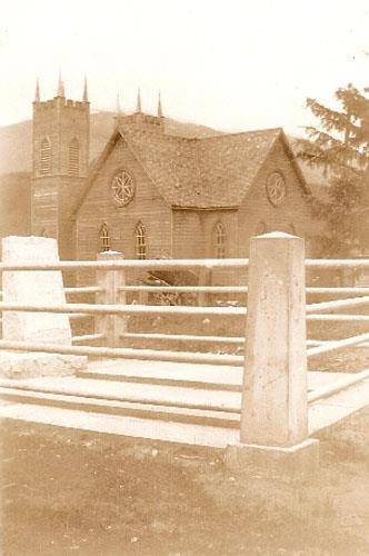 Tomlinson Grave with Meanskinisht Church in background; Regional District of Kitimat-Stikine, 2014