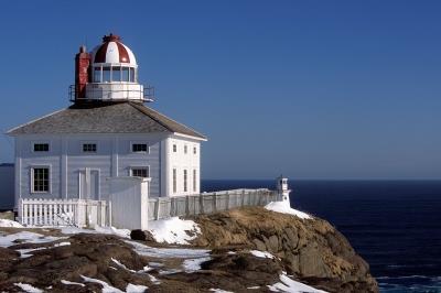Corner view of Cape Spear (Old) Lighthouse showing its distinctive profile, consisting of a circular stone lighttower with a two storey, cubic building of wooden structure constructed around it, 2004; Parks Canada Agency | Agence Parcs Canada, H.01.13.01.10.09.