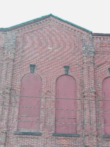 This photograph shows the roof-line in the center of the façade.; City of Saint John 2004