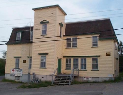 View of front and right facades, St. George's Court House, St. George's, NL, prior to restoration in 2004, showing missing tower roof.; HFNL 2005