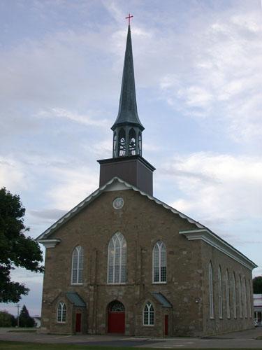 Front view of the church facade illustrating the iron bell tower, Gothic style door arch and bull’s eye stained glass window. ; PNB 2005