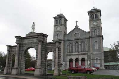 General view of the Basilica of St. John the Baptist and the Triumphal Arch, 2006.; Parks Canada Agency / Agence Parcs Canada, R. Goodspeed, 2006.