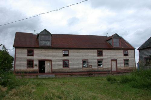 Front facade view of the building illustrates the open plan along with the window and door arrangement being clear expressions of the function of the building.; PNB 2004