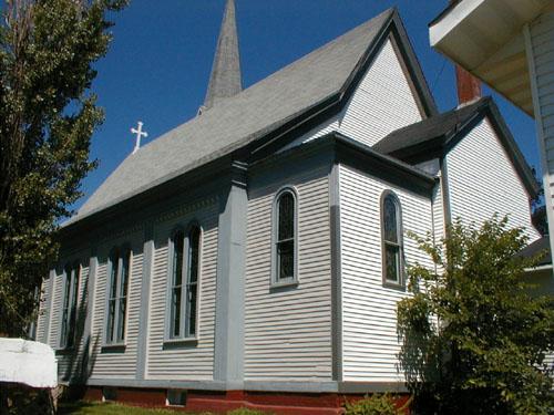 This image shows three of the four sets of double Italianate windows along the side of the building.; PNB 2005