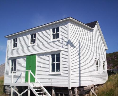 View of front facade and right gable end of the John Quinton Limited Shop, Red Cliffe, NL, showing the roofline of the original structure and the storefront addition, taken September 24, 2006; HFNL/Dale Jarvis 2006
