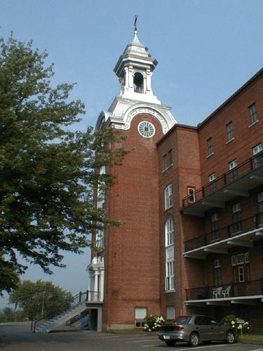 View of the main bell tower, which dominates the entire building, and the numerous balconies, verandas, and steps on the various levels.; PNB 2005