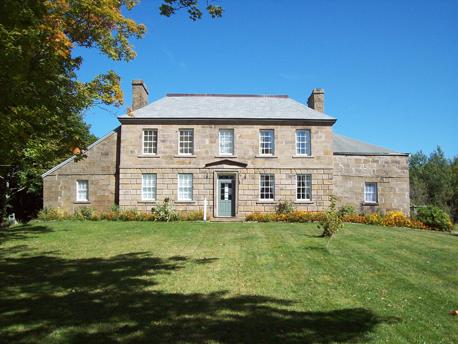Front façade view of the building illustrates its Palladian architectural design expressed by the symmetrical and ordered structure of two single-storey lateral wings flanking a main two-storey central block.; PNB 2009